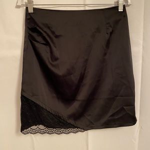 Black silk skirt with lace detail, pleated in top left corner